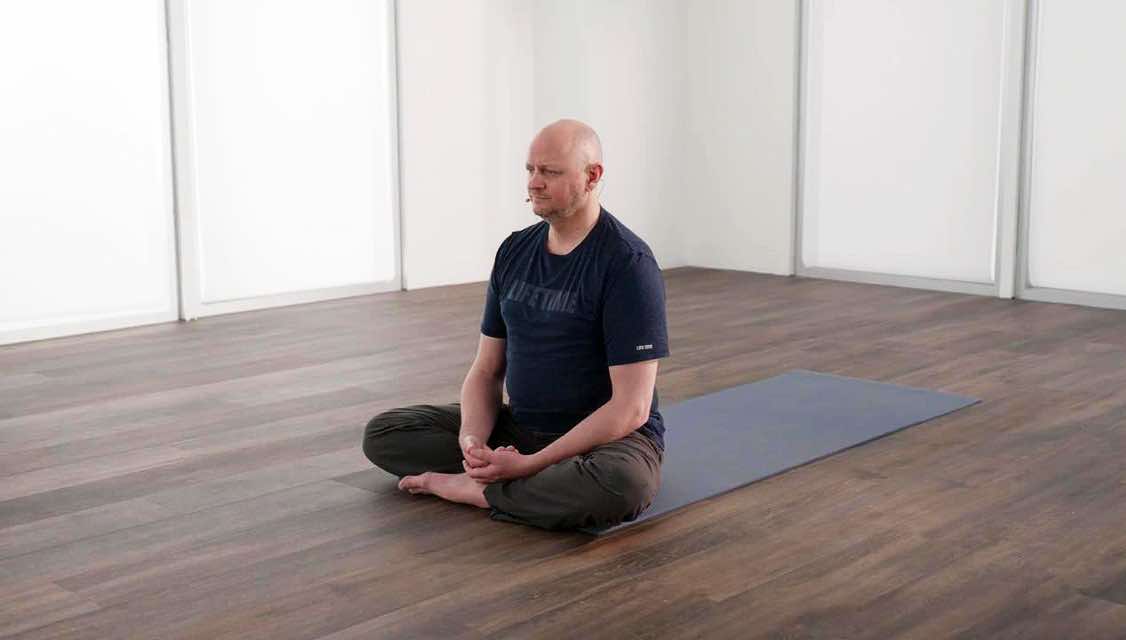 Man in a seated yoga pose
