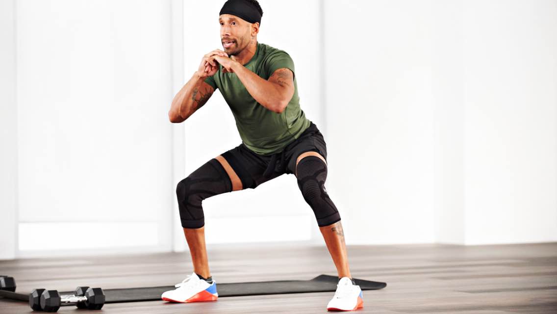 a man performs an air squat