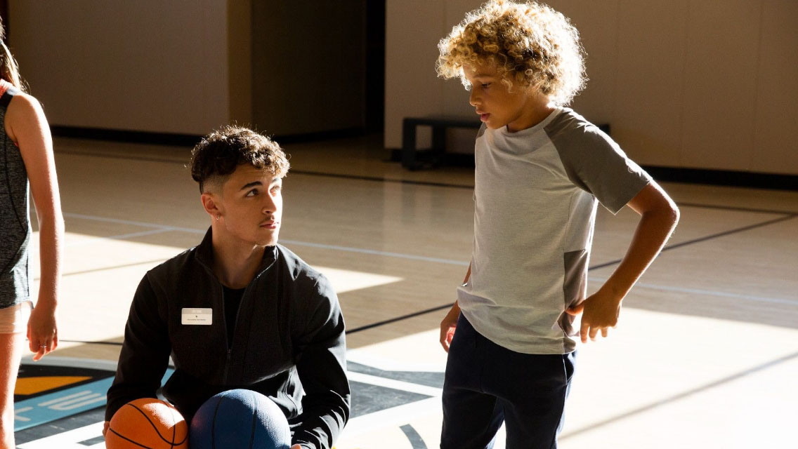 an instructor and child getting ready to play a game together