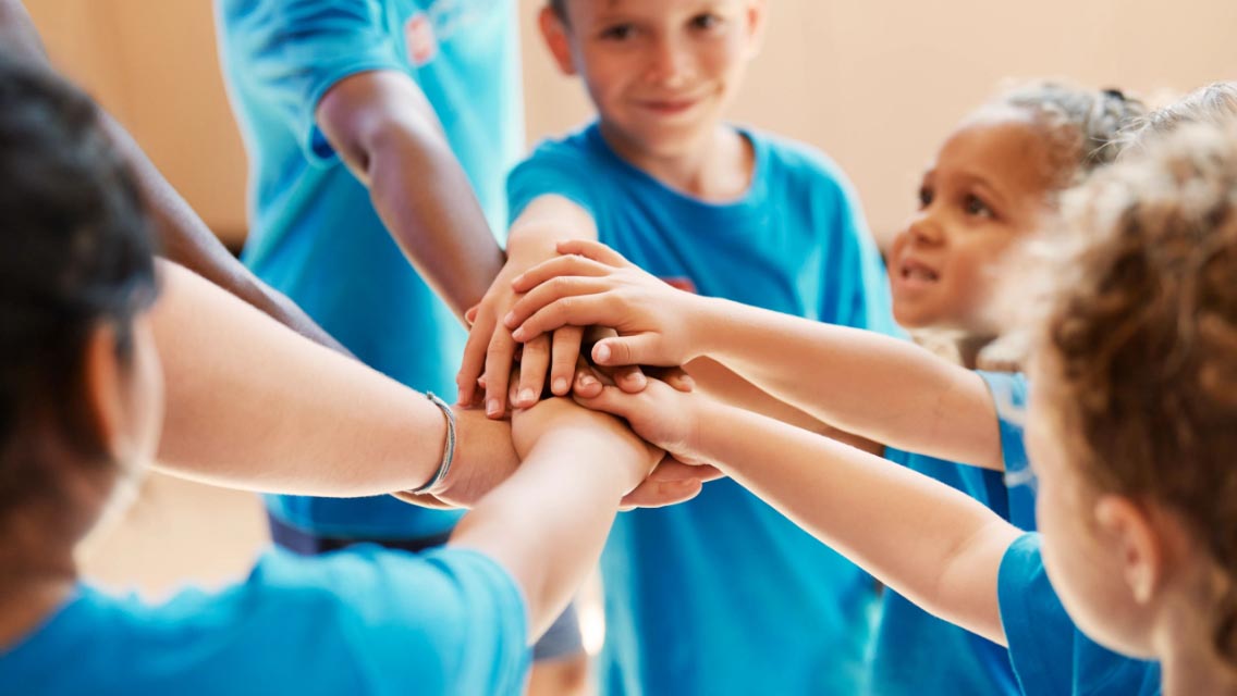 kids cheering together, kids embracing one another, kids with hula hoops