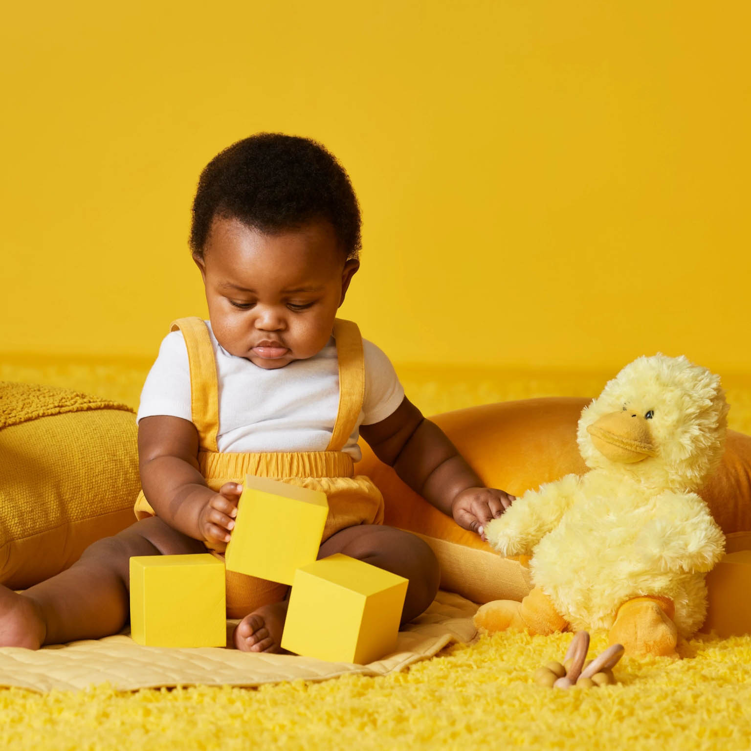 an infant playing with multiple sensory toys