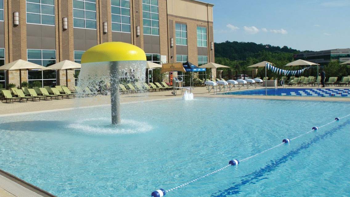 An outdoor pool with water fountain
