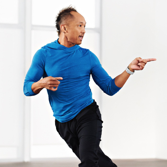 Woman taking a Zumba class at home with Life Time Classes On Demand