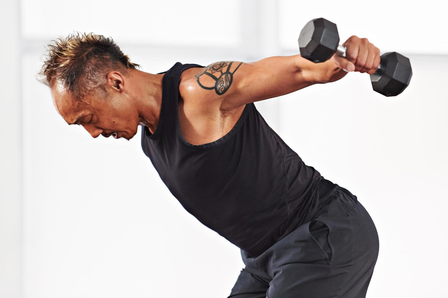 A man taking a Barbell Strength class at home with Life Time Classes On Demand. 