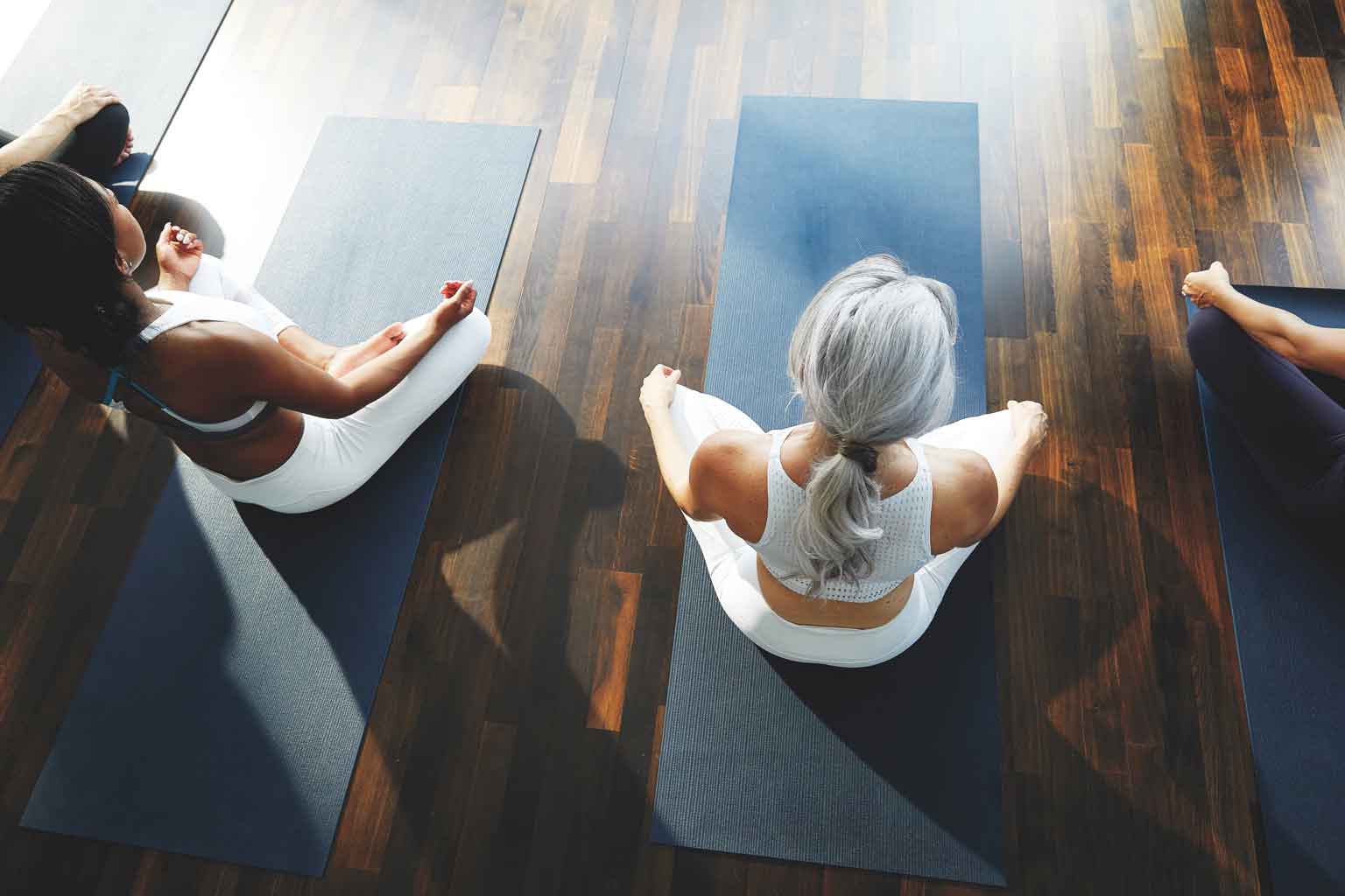 a woman being mindful and relaxed in a yoga class