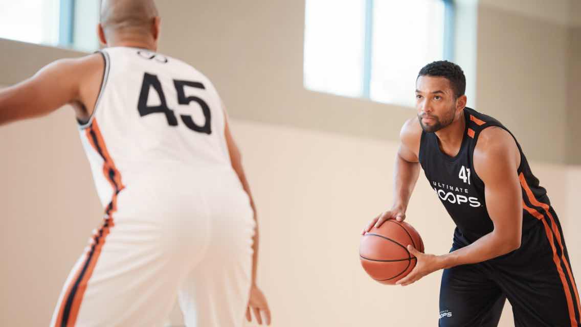 Two men playing basketball.  