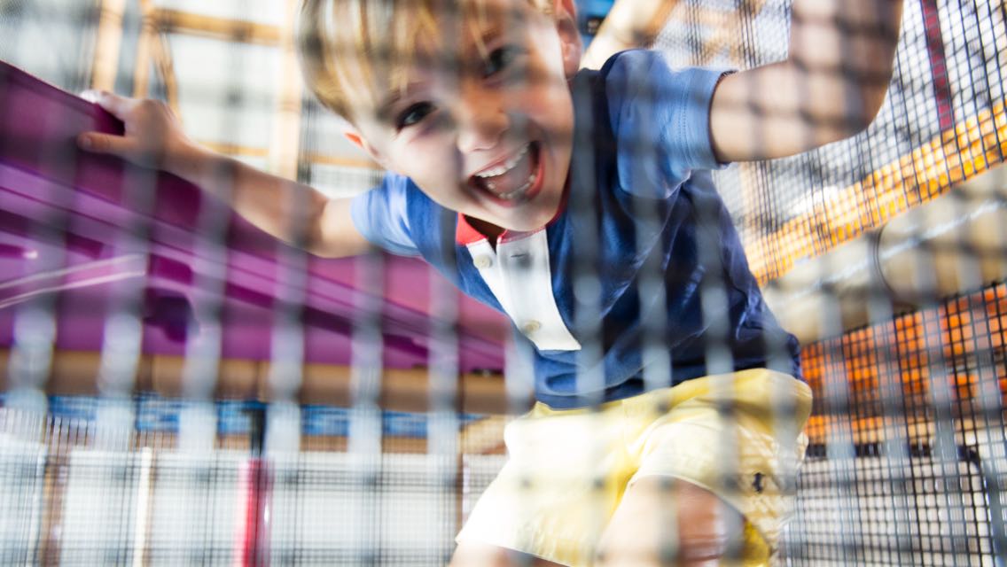 A small child playing on an indoor playground 