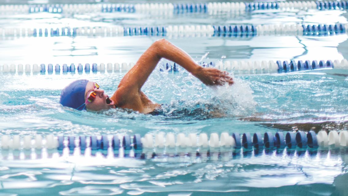 A person swims laps in the Life Time lap pool.