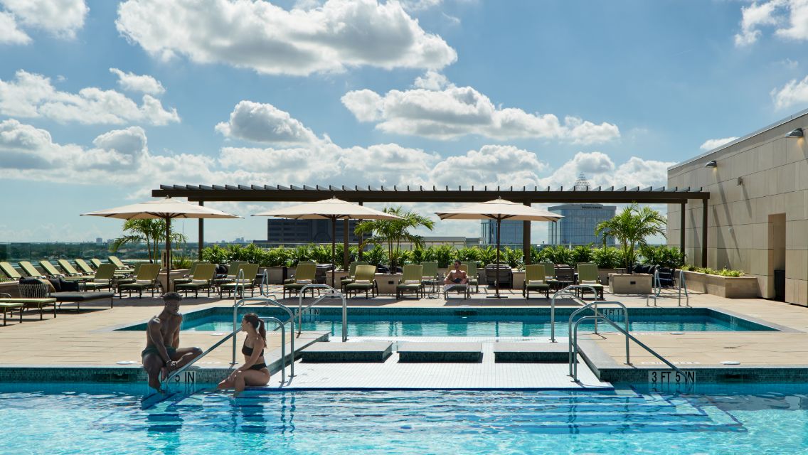 A view of the Life time outdoor Beach Club which features multiple pools as well as a club-like atmosphere.