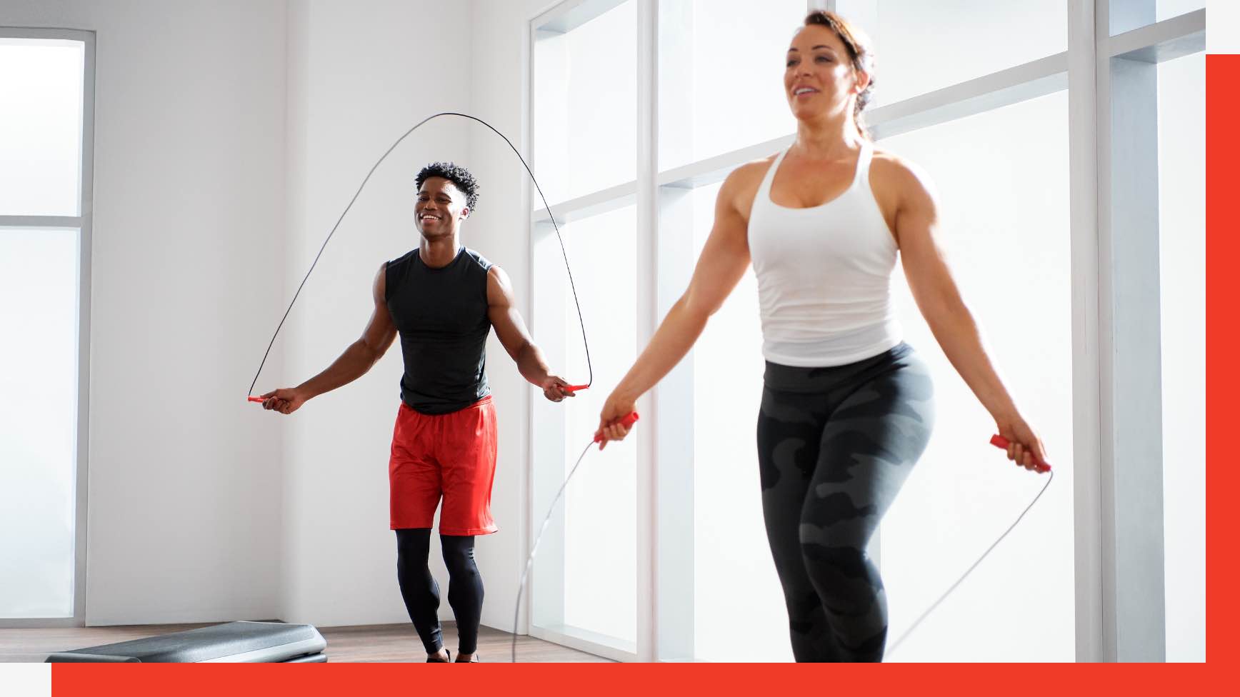 Two people jumping rope in a group fitness class at Life Time
