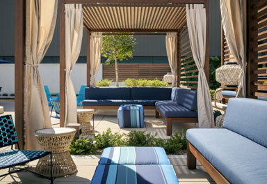 benches with blue cushions under an oudoor cabana