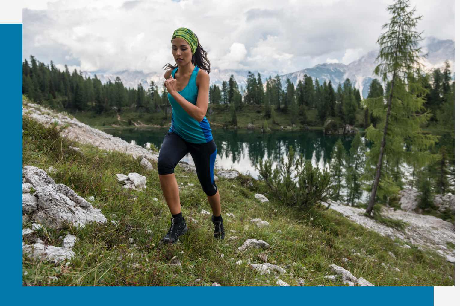 Woman running outside up a mountain.