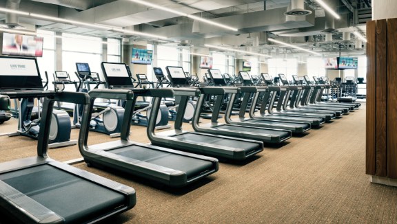 Row of treadmills on the fitness floor at Life Time