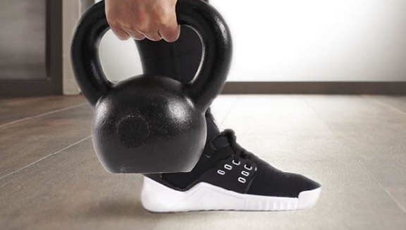 Close view of a person holding a kettlebell