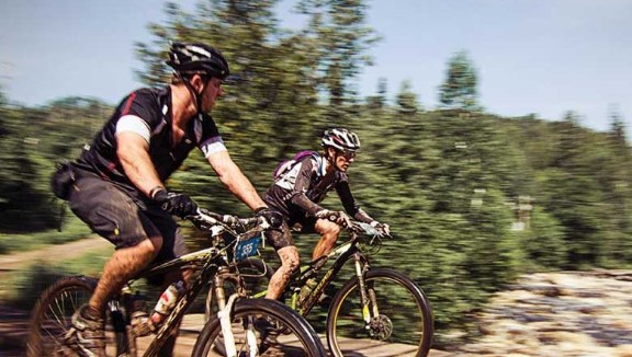 Two people riding bikes on an outdoor trail