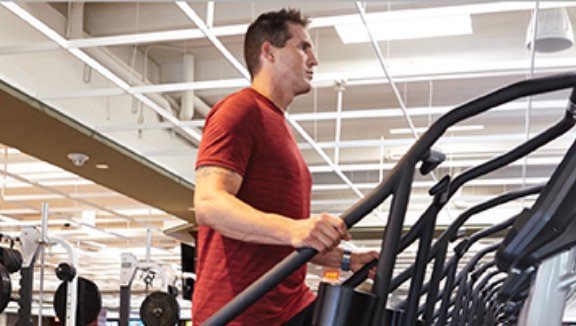 Man working out on a stair-stepper machine