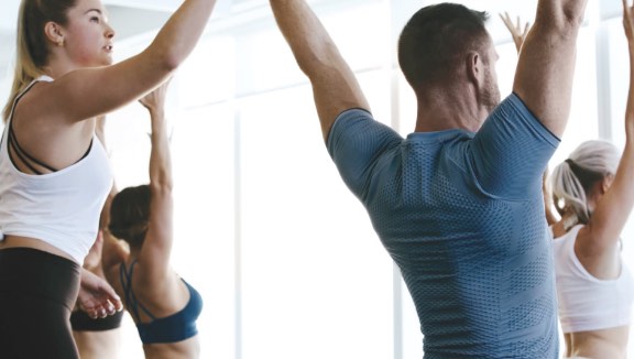 Yoga class participants holding a yoga pose