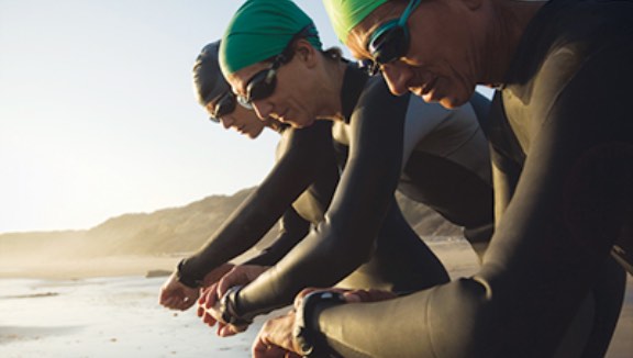 Three people ready to start an outdoor triathalon