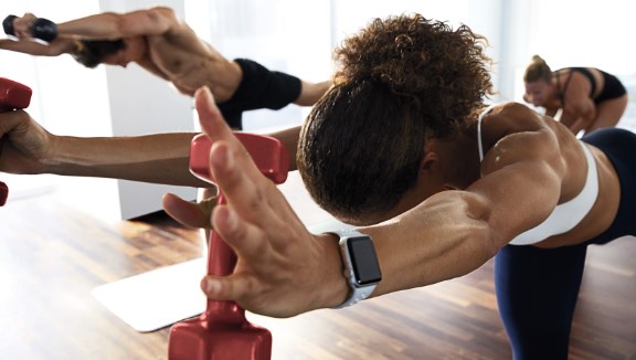 Three people working out in a Warrior Sculpt class at Life Time