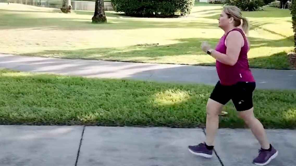 Woman running on sidewalk. 