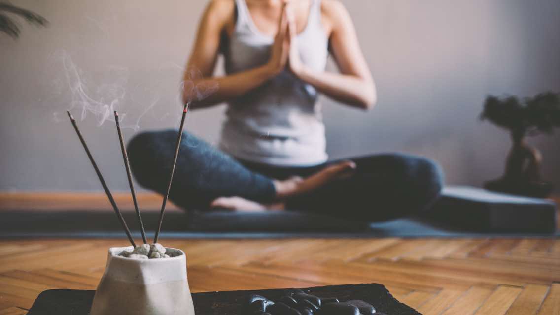 Woman doing yoga in a yoga studio at Life Time