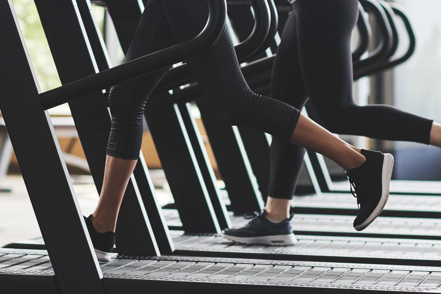 Legs moving on a row of treadmills at Life Time