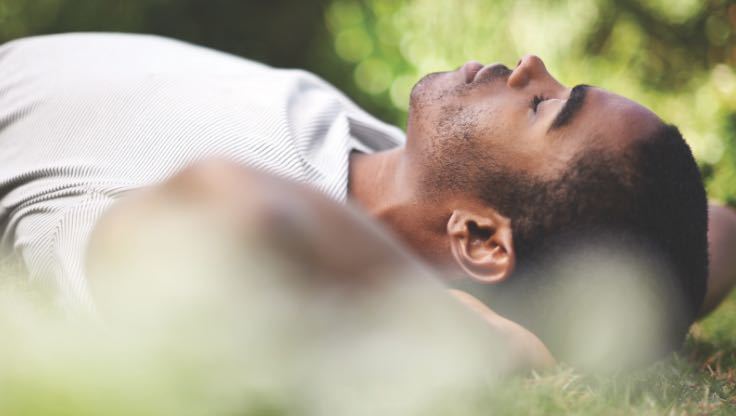 Man relaxing and lying on the grass. 