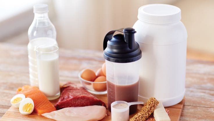 30 grams of protein displayed as a protein shake, milk, eggs, meat and nuts, 