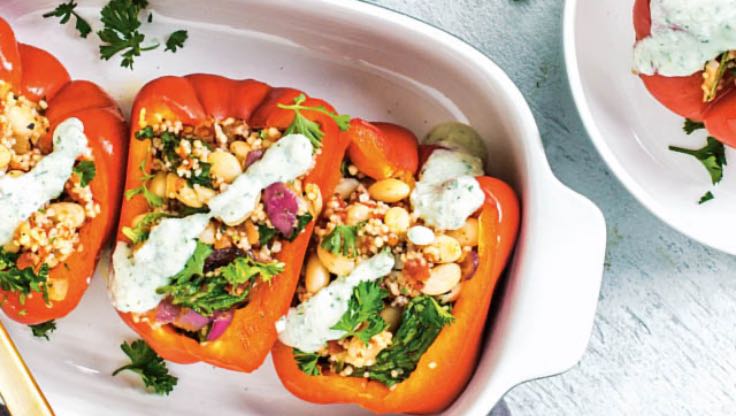 Three stuffed bell peppers in a pan. 