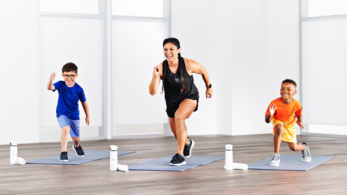 a women and 2 children do a workout together