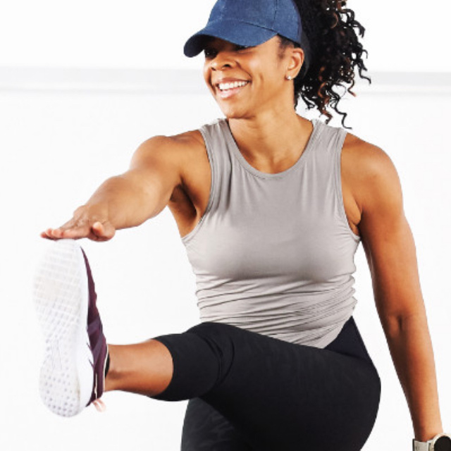 Woman taking a shred class at home with Life Time Classes On Demand