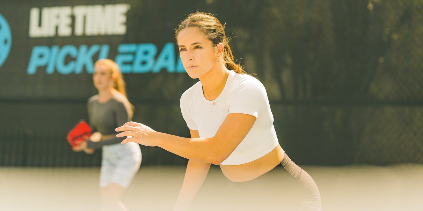 a woman playing pickleball