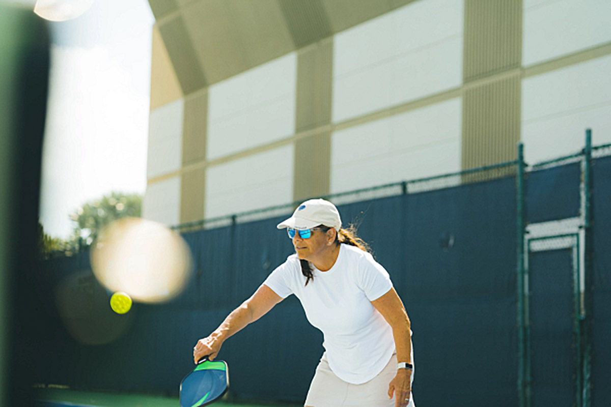 a woman going after a pickleball