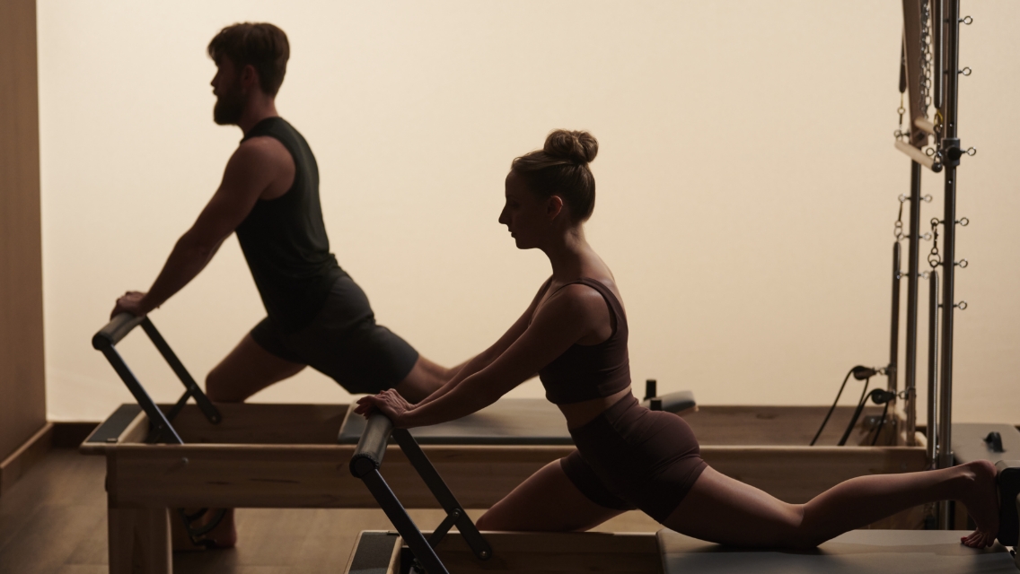 a woman and a man in a pilates class
