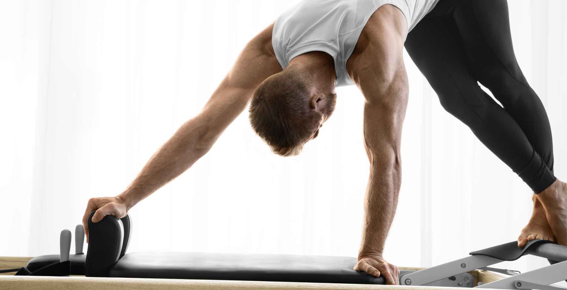 A Pilates student working out on a reformer 