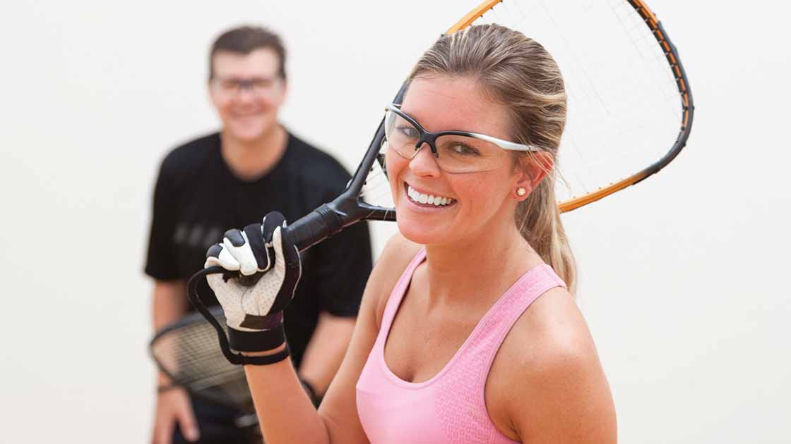 Image of two happy adults wearing racquetball gear