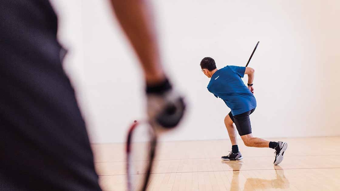 Image of a man taking a swing in a tennis game