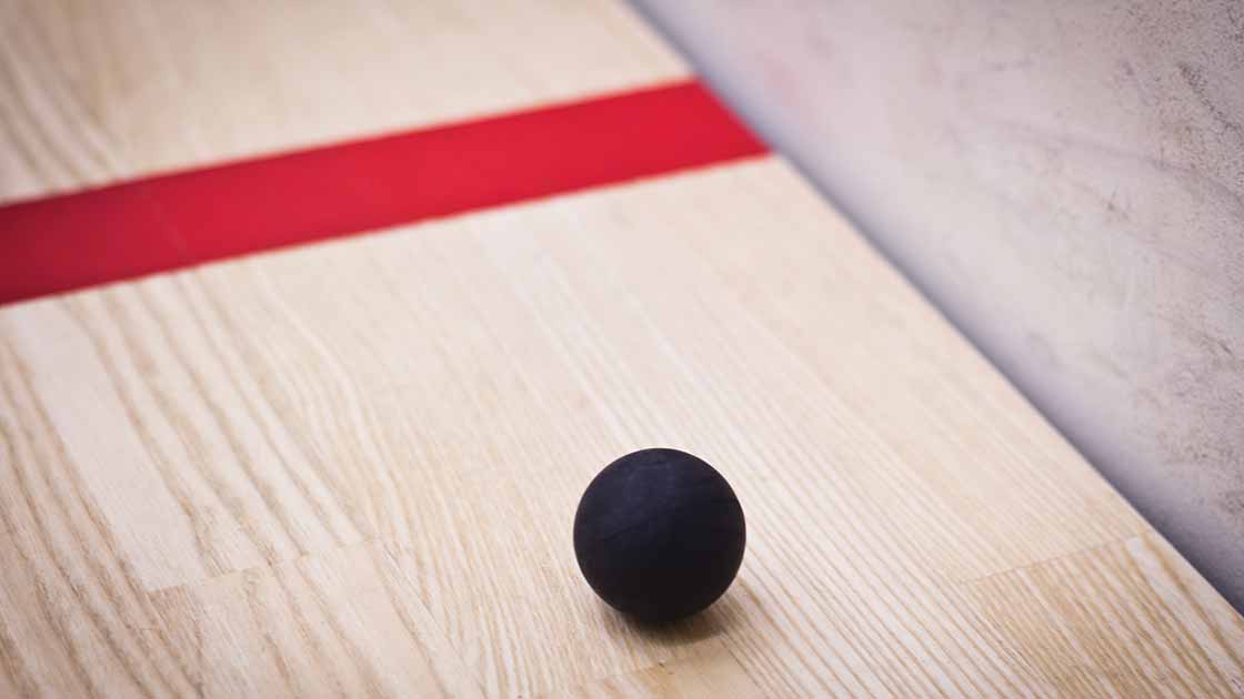 A squash ball on a court floor