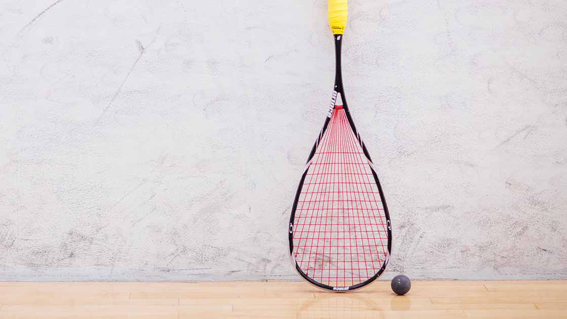 A squash racquet and ball