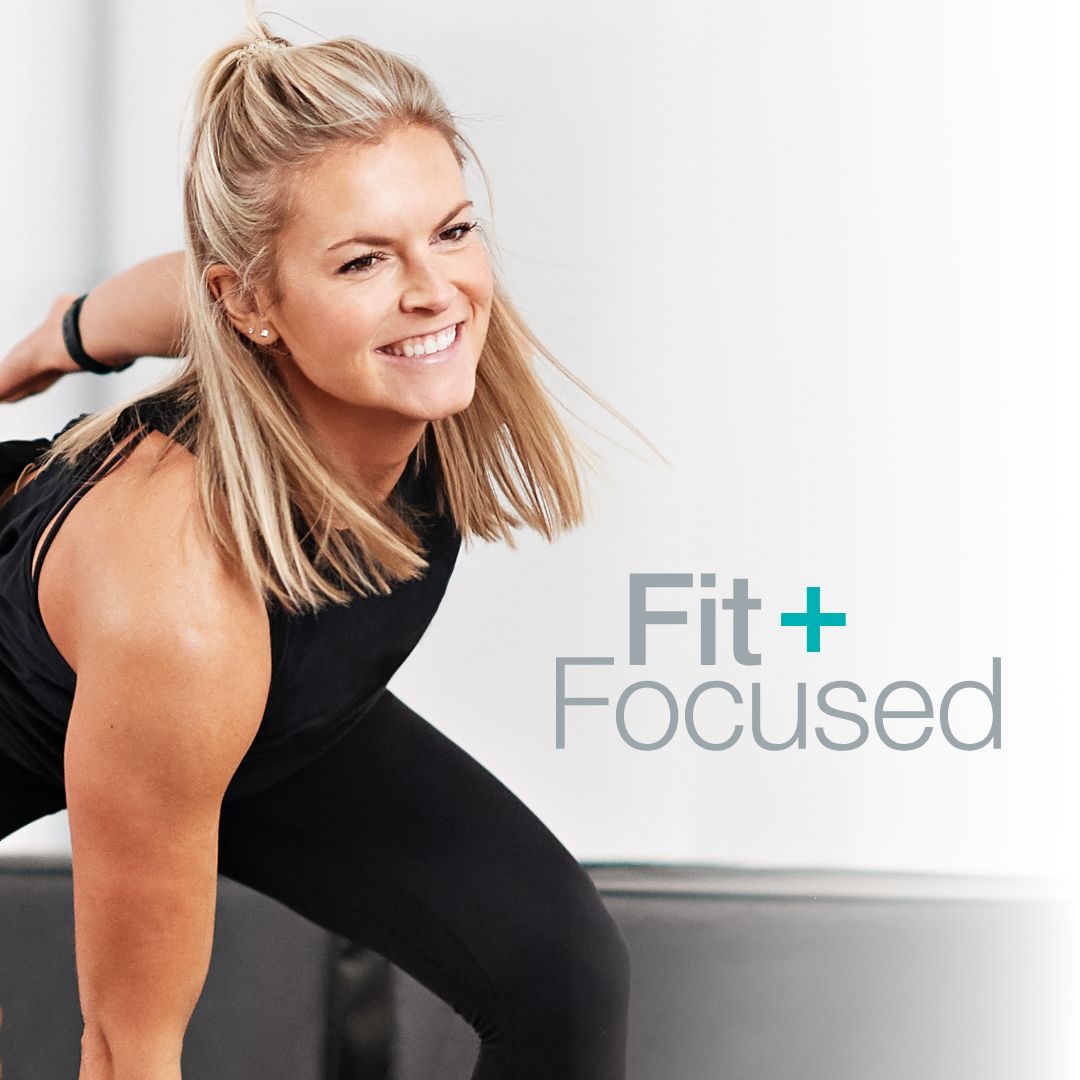 a woman does a fitness routine with the Fit + Focused logo next to her.