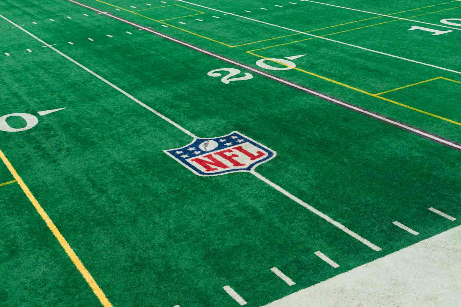 Image of a green turf field at Life Time Winter Park with the National Football League logo on it.
