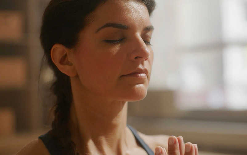 woman in a yoga class taking a deep breath