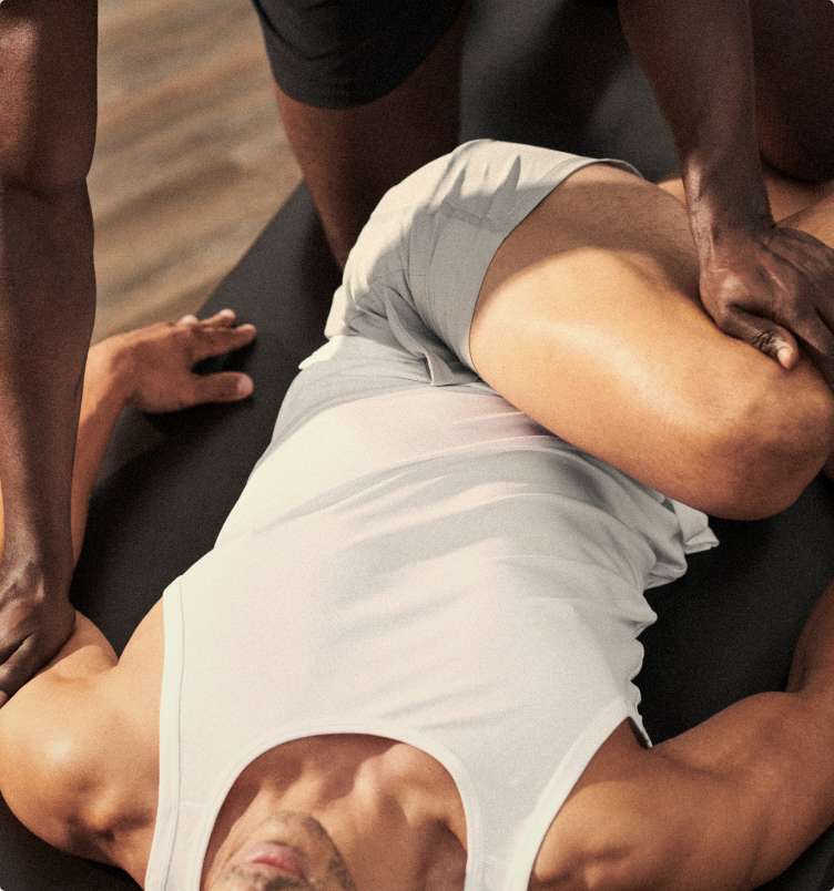 a man getting stretched by a trainer